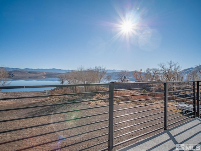 exterior space with a water and mountain view