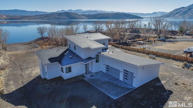 aerial view featuring a water and mountain view