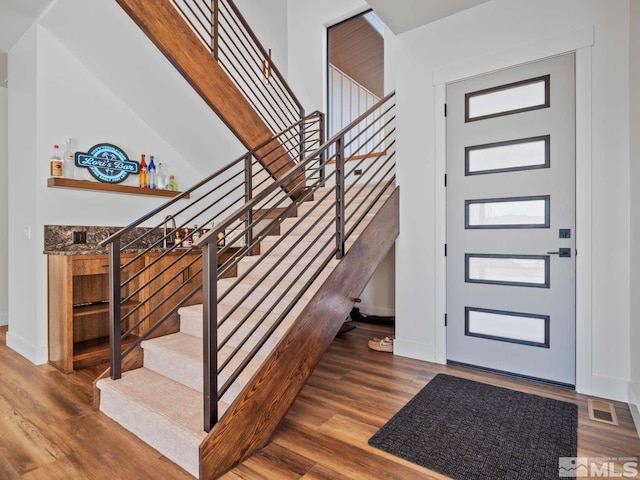 foyer entrance featuring dark hardwood / wood-style floors