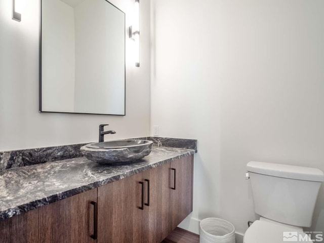 bathroom featuring vanity and toilet