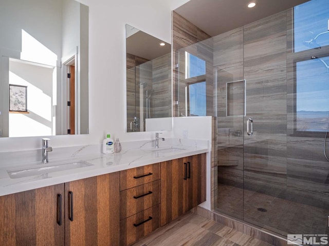 bathroom with vanity and a shower with shower door