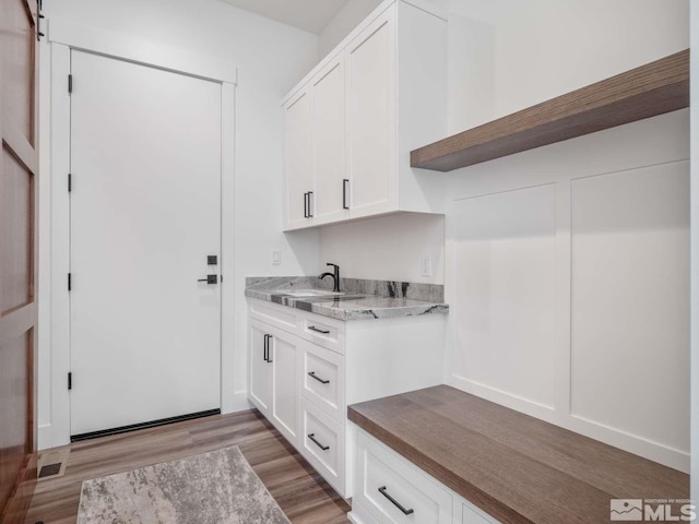 mudroom with sink and light wood-type flooring