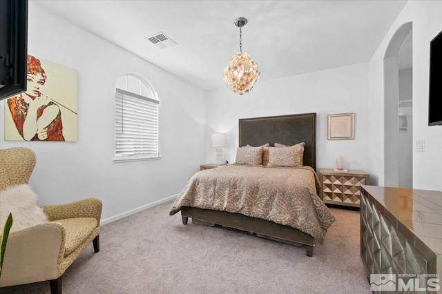 bedroom with a notable chandelier and carpet floors