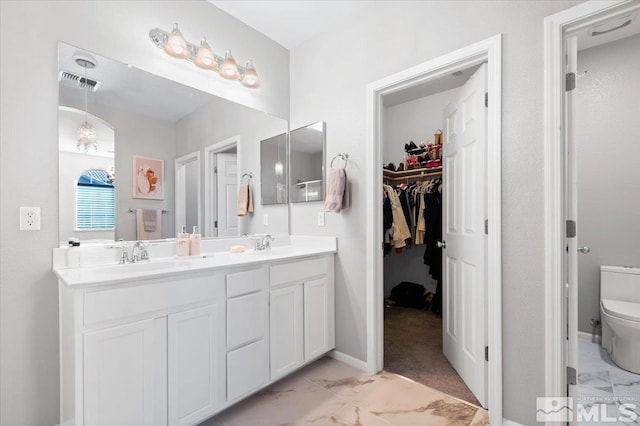 bathroom with vanity and toilet