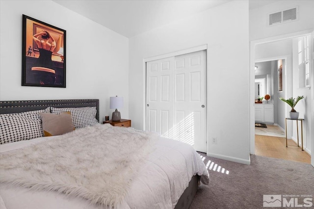 carpeted bedroom with a closet