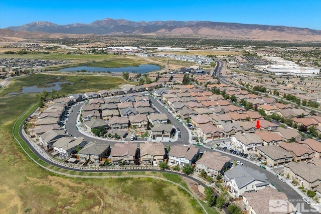 aerial view featuring a water and mountain view