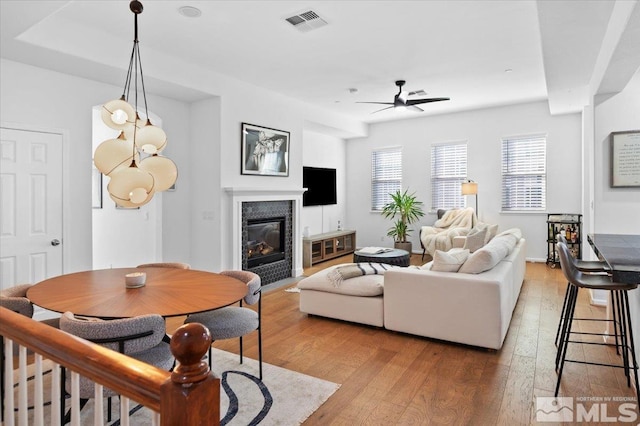 living room featuring light hardwood / wood-style floors and ceiling fan