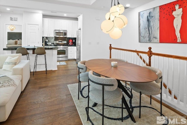 dining area with dark wood-type flooring and sink