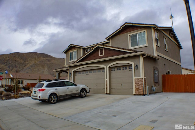 view of front facade featuring a garage and a mountain view