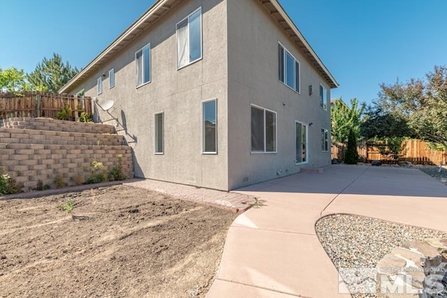 view of property exterior featuring a patio area