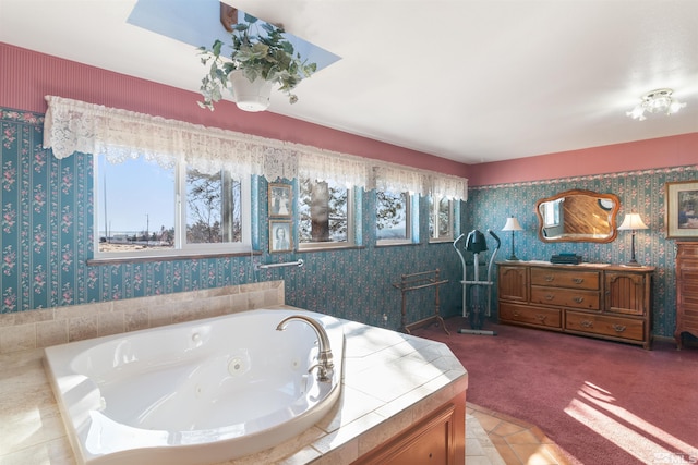 bathroom with a relaxing tiled tub and a wealth of natural light