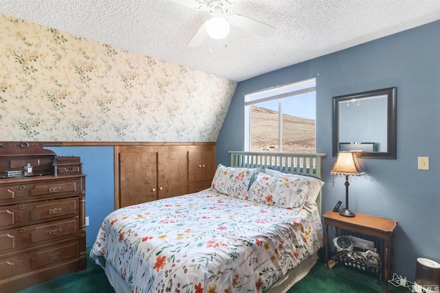 carpeted bedroom with ceiling fan, vaulted ceiling, and a textured ceiling