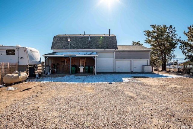 back of house featuring an outbuilding