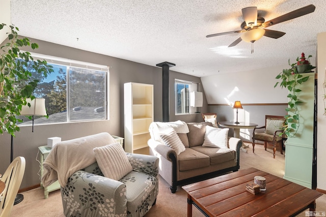 carpeted living room with ceiling fan and a textured ceiling