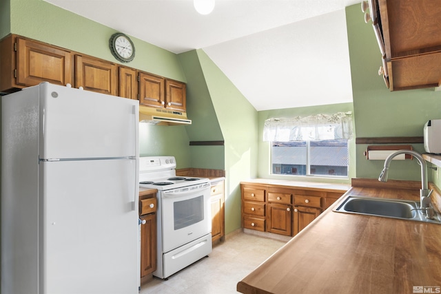 kitchen featuring lofted ceiling, sink, and white appliances