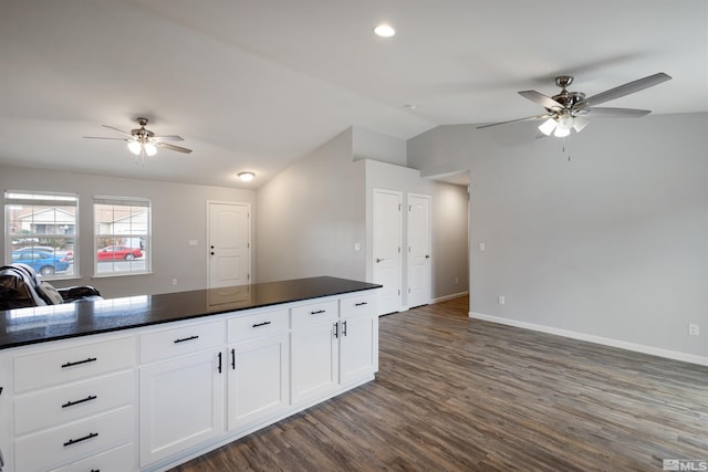 kitchen with lofted ceiling, ceiling fan, dark hardwood / wood-style floors, and white cabinets