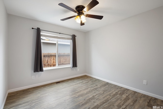 empty room with wood-type flooring and ceiling fan