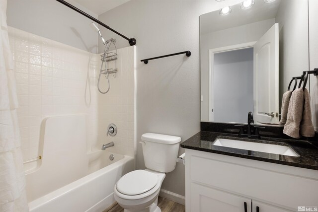 full bathroom with vanity, wood-type flooring, shower / bath combination with curtain, and toilet