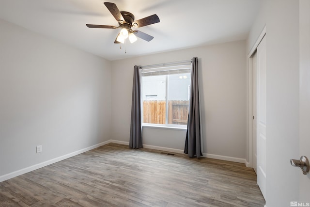 unfurnished room with ceiling fan and light wood-type flooring