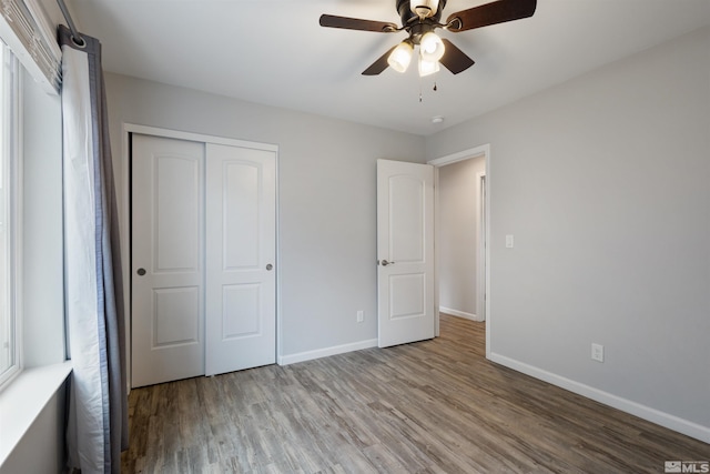 unfurnished bedroom featuring a closet, ceiling fan, and light wood-type flooring