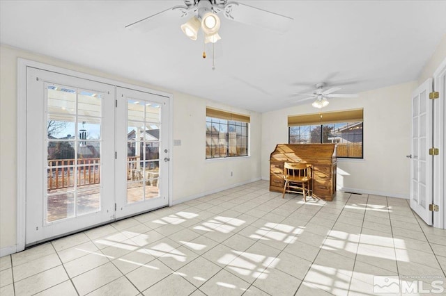 unfurnished dining area featuring ceiling fan and light tile patterned floors