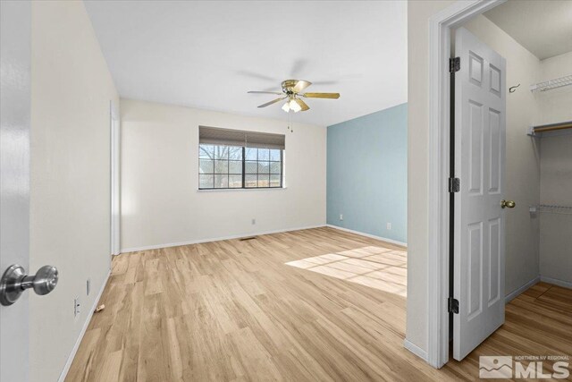 unfurnished room featuring ceiling fan and light hardwood / wood-style floors