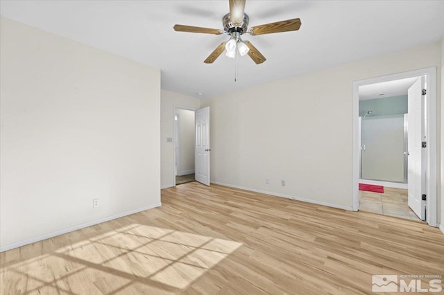 unfurnished bedroom featuring connected bathroom and light hardwood / wood-style floors
