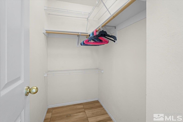 walk in closet featuring hardwood / wood-style floors