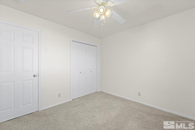 unfurnished bedroom with carpet floors, ceiling fan, and a closet