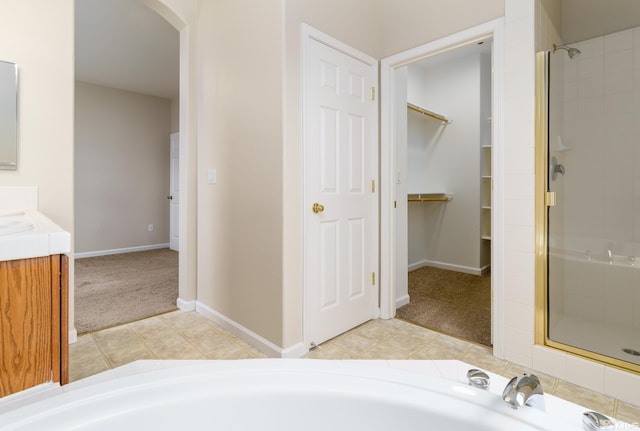 bathroom featuring tile patterned floors, vanity, and plus walk in shower