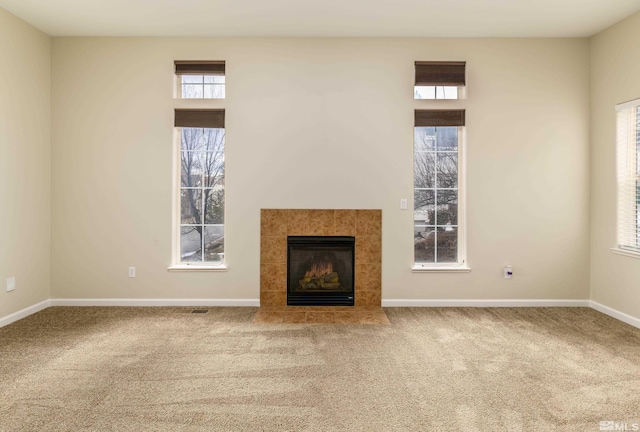 unfurnished living room featuring a fireplace and carpet flooring