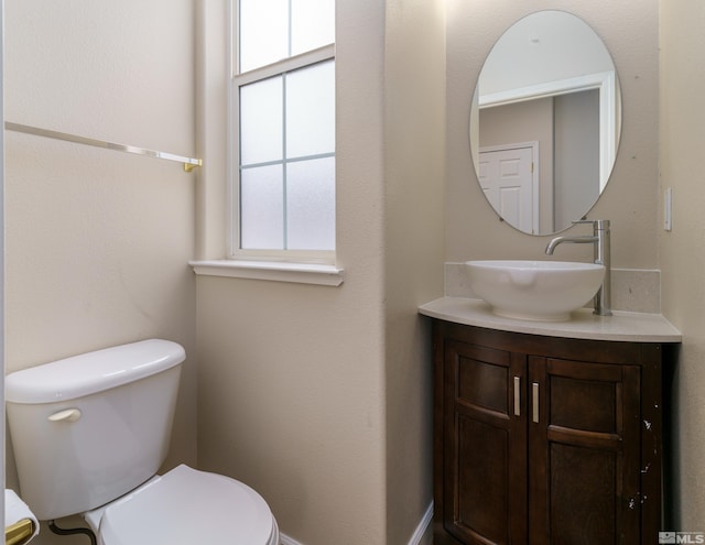 bathroom with vanity, plenty of natural light, and toilet