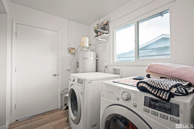 washroom featuring laundry area, independent washer and dryer, and light wood-style flooring