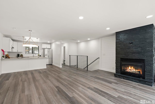 unfurnished living room with hardwood / wood-style flooring and a fireplace