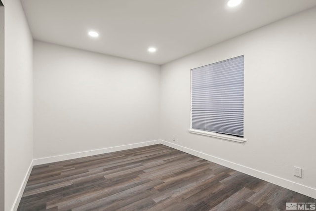 spare room featuring dark hardwood / wood-style flooring