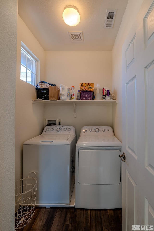 washroom featuring washer and dryer and dark wood-type flooring