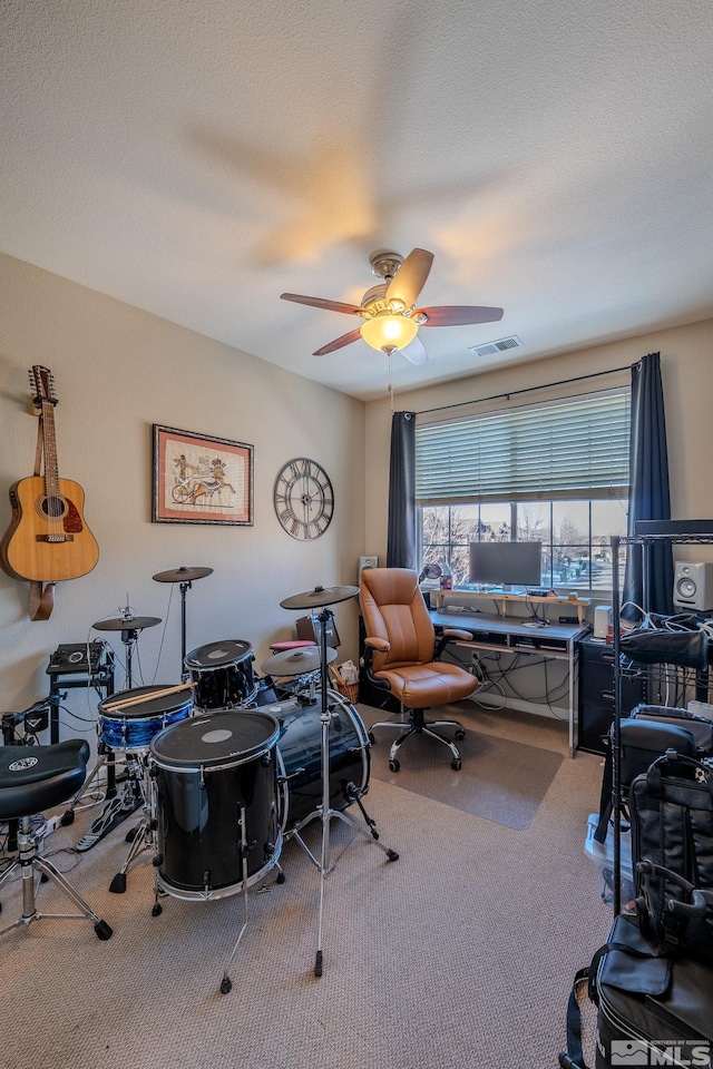 interior space with ceiling fan and a textured ceiling