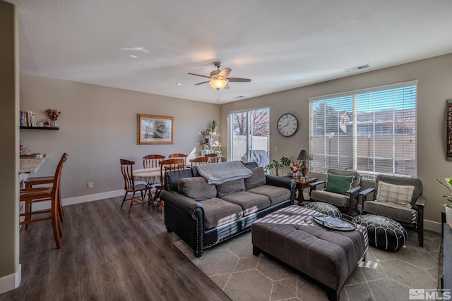 living room with ceiling fan, a healthy amount of sunlight, wood-type flooring, and a textured ceiling