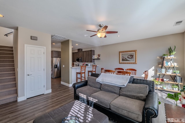 living room with dark wood-type flooring and ceiling fan