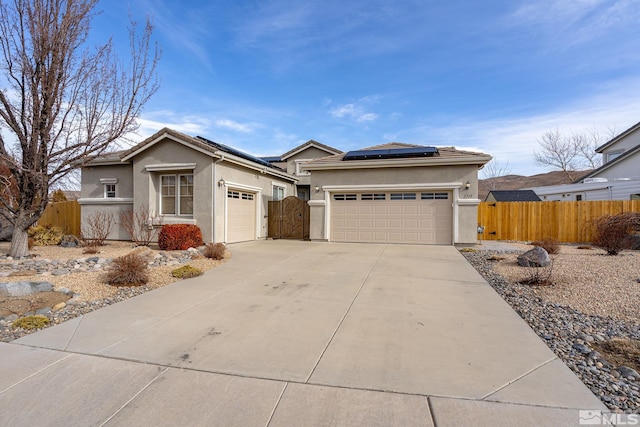 view of front facade with a garage and solar panels