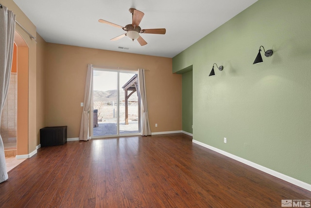 unfurnished room featuring ceiling fan and dark hardwood / wood-style flooring