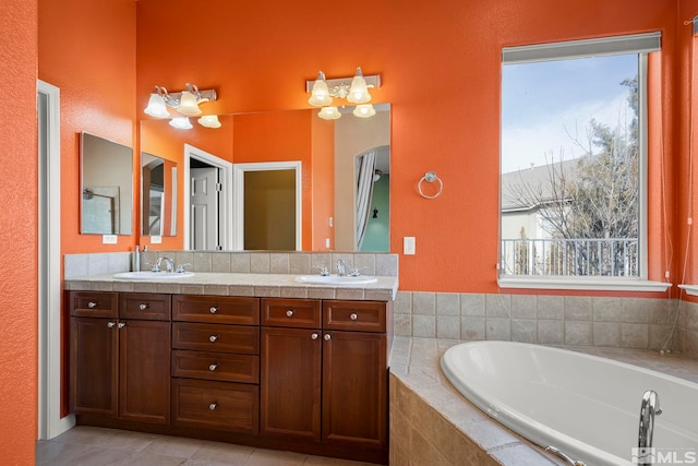 bathroom with vanity, tiled bath, and tile patterned floors