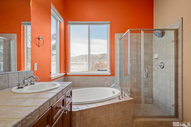 bathroom featuring vanity, a mountain view, and shower with separate bathtub