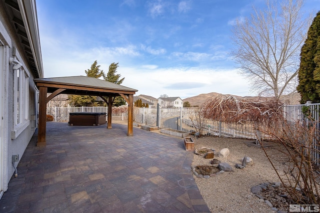 view of patio featuring a gazebo and a hot tub