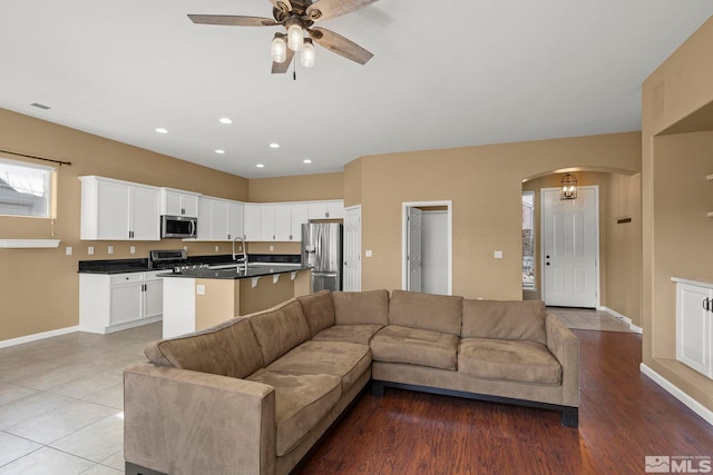 living room with sink and ceiling fan