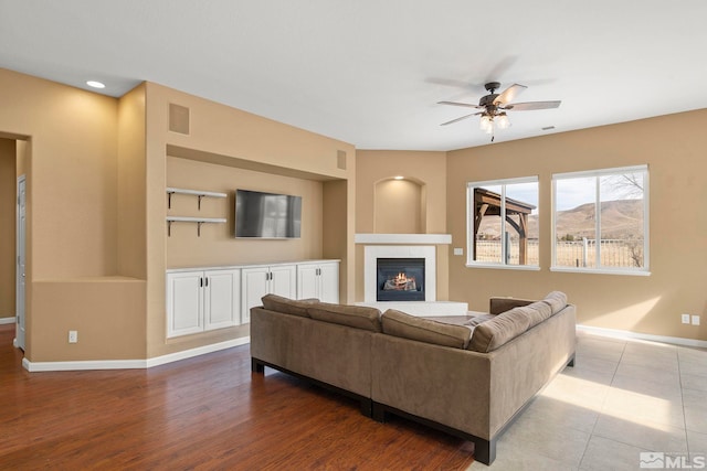 living room with ceiling fan and wood-type flooring