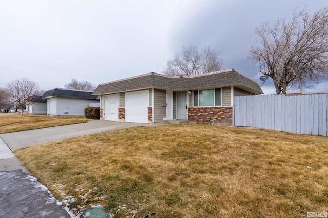 ranch-style house with a garage and a front yard