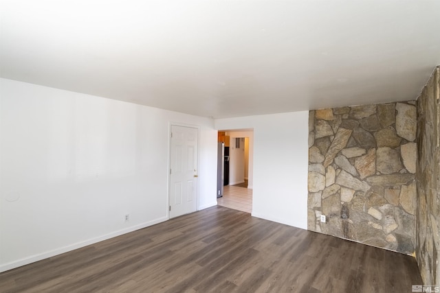 spare room with dark wood-type flooring