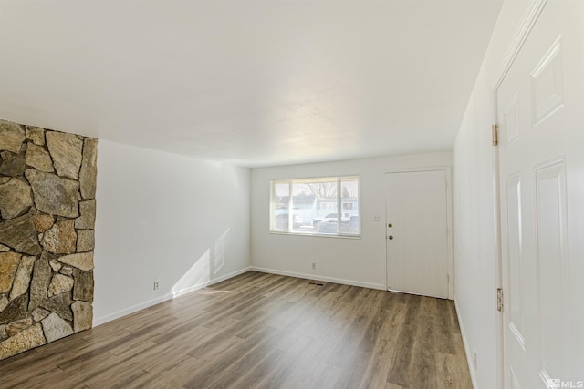 unfurnished living room with wood-type flooring