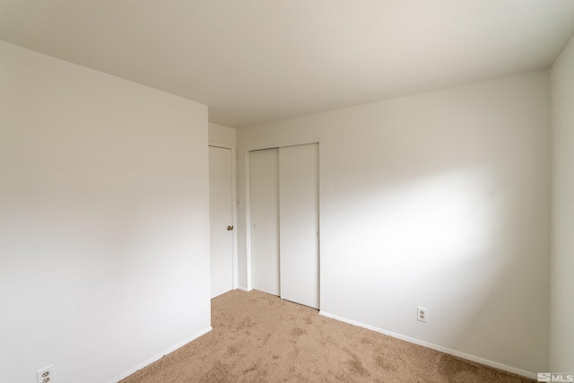 unfurnished bedroom featuring a closet and carpet